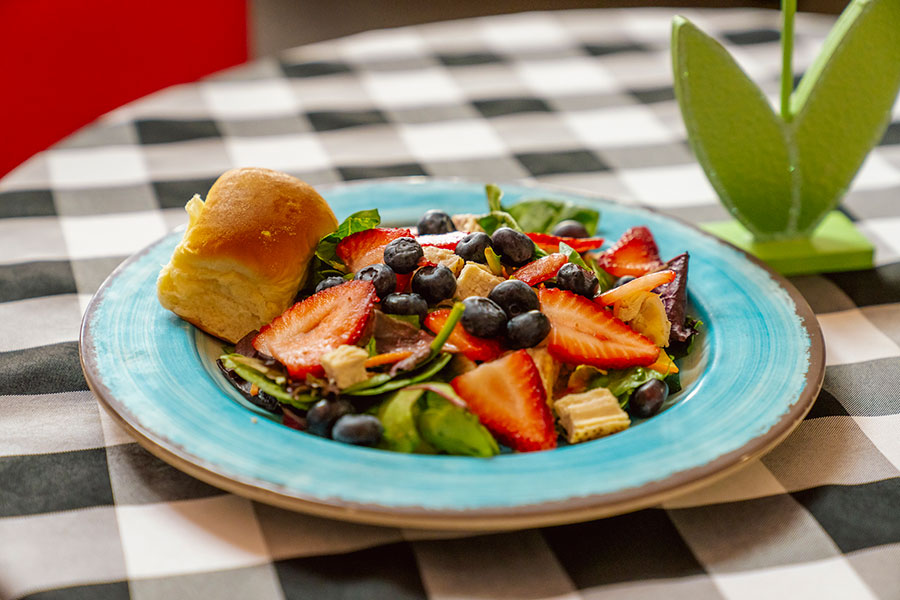 delicious blueberry and strawberry salad with dinner roll