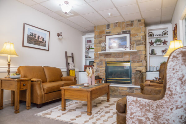 Cozy living room with fireplace in The Chesterly at Rexford Park 