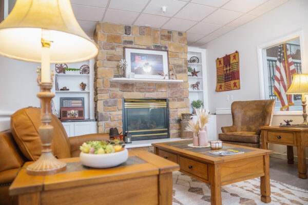 Cozy living room with fireplace in The Chesterly at Rexford Park 