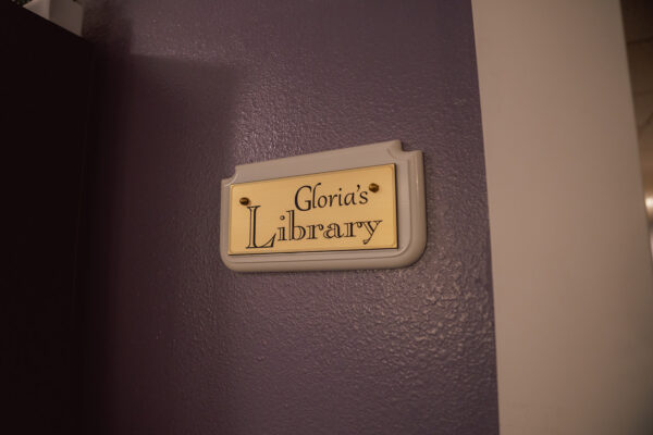 Close-up of Gloria's Library signage in The Manor at Rexford Park