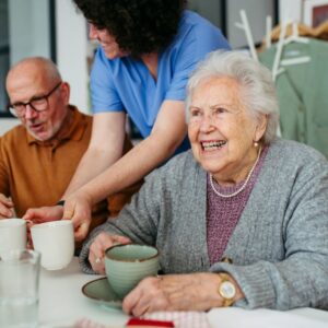An older woman smiling in a senior living community.