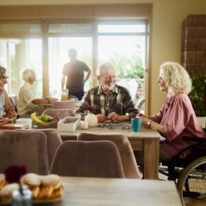 A group of older friends socialize in a senior living community.